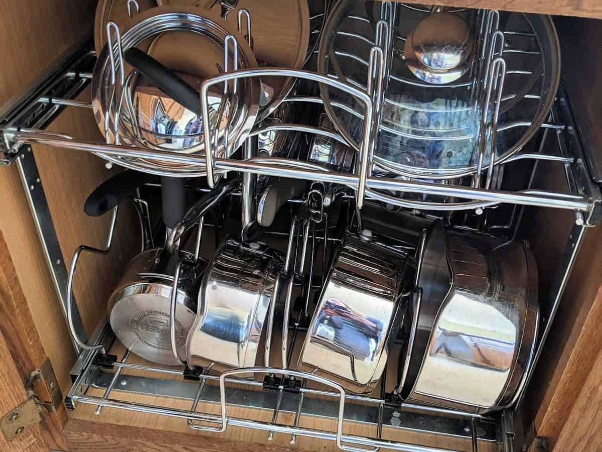 pull-out pots pans and lids organizer with stainless cookware